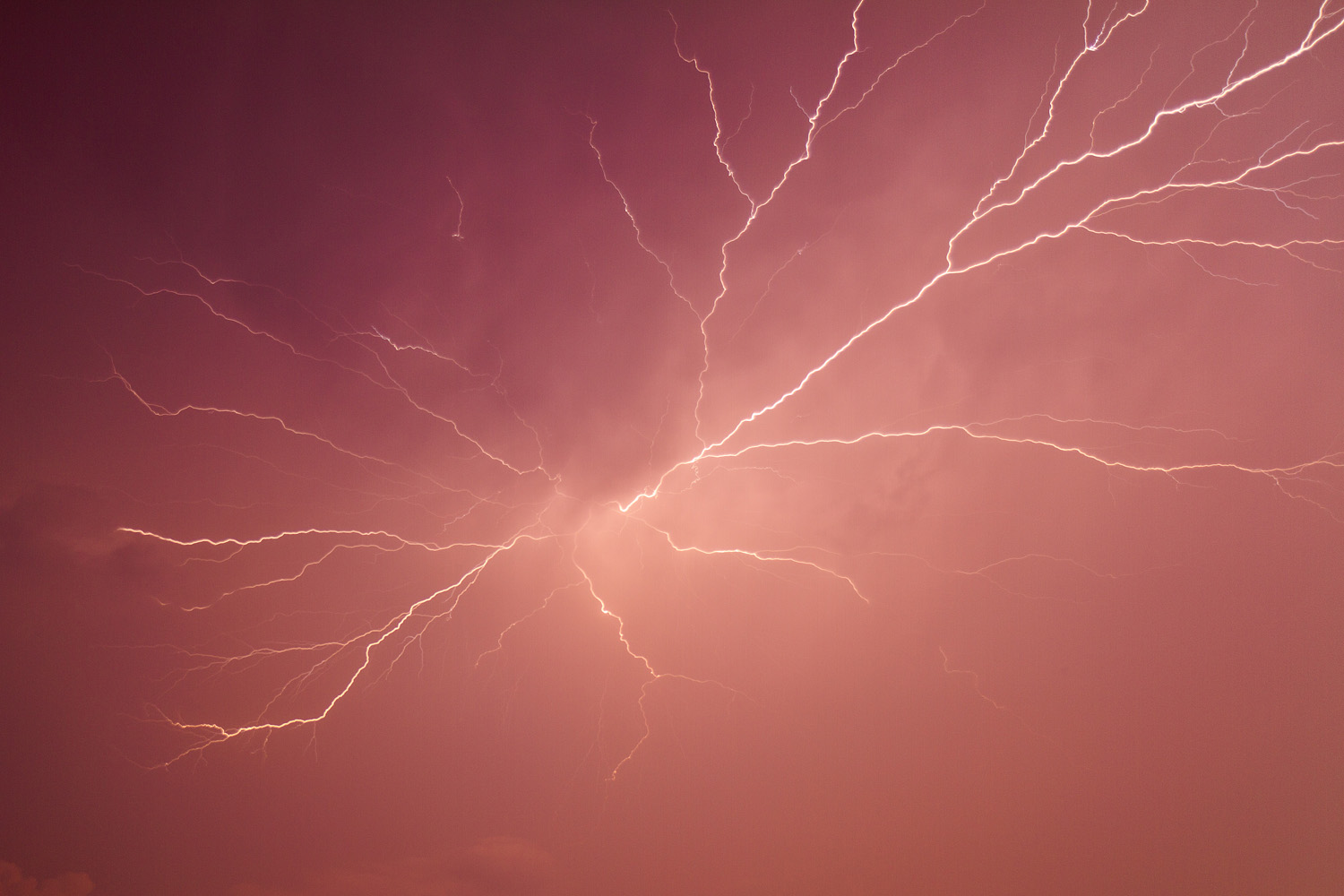 Lightning strike in magenta sky via DoubleStrike.com